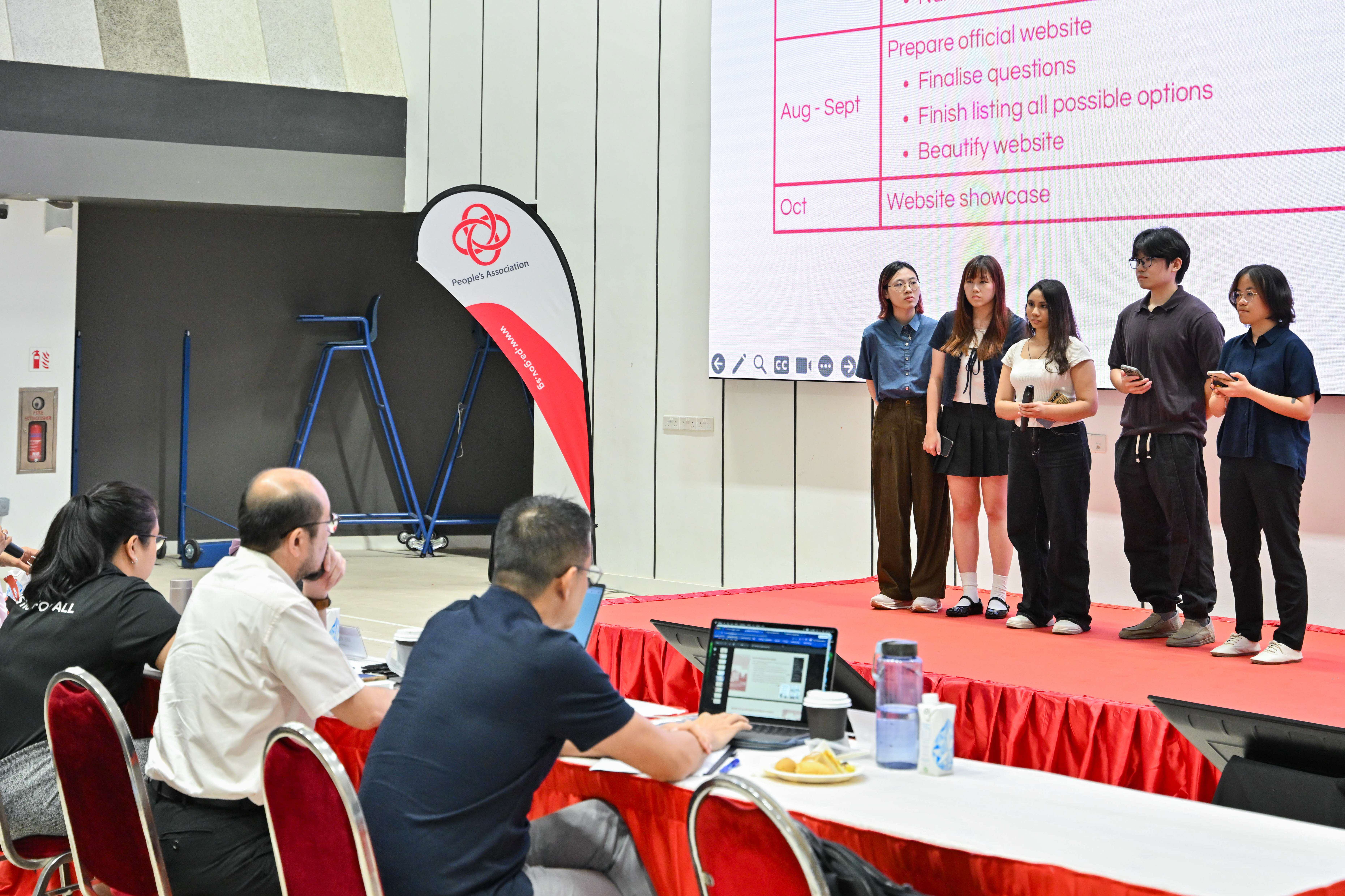 Five students listening to the feedback from the panel